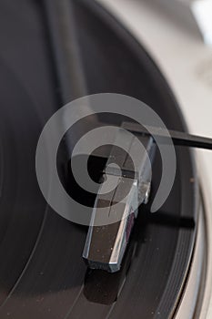 Closeup shot of headshell in a portable gramophone with a blurred background