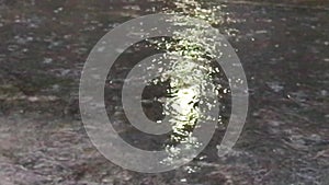 Closeup shot of heavy rain on road on water surface