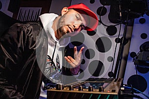 Closeup shot of a Hispanic boy sitting near the synthesiser