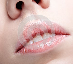 Closeup shot of human female face. Woman with pink plump lips makeup
