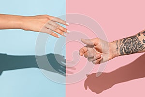 Closeup shot of human holding hands isolated on yellow studio background.