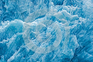 Closeup shot of the ice texture of a blue glacial wall in Inside Passage, Alaska