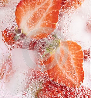 Closeup shot of iced strawberries in a glass