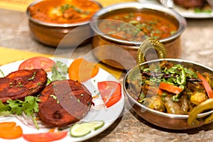 Closeup shot of Indian restaurant non-vegetarian thali with rice, puri