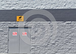 Closeup shot of an industrial building exterior wall sign with an inscription \'\'Cameras In Use