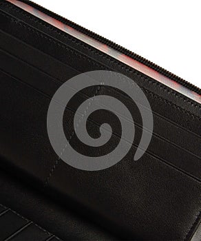 Closeup shot of the inner pockets of an open black wallet