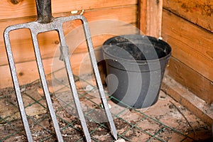 Closeup shot of an iron rake in the wooden hut