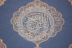 Closeup shot of Islamic Book Quran with golden arabic calligraphy