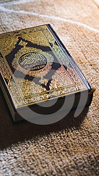 Closeup shot of Islamic Book Quran with golden arabic calligraphy left side