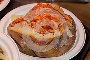 Closeup shot of jacked potatoes in a plastic plate in London, England