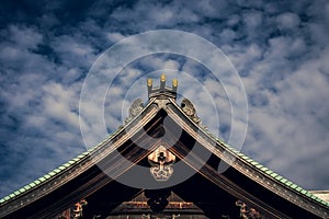 Closeup shot of Japanese temple on blue sky and white clouds background