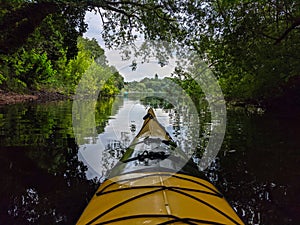 Closeup shot of a kayak on a  river surrounded by trees in the German city Ploen photo