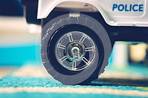 Closeup shot of a kid's toy car wheel on a carpet