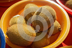 Closeup shot of kiwis in a small yellow bowl