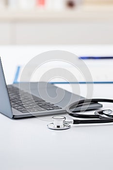 laptop, stethoscope and doctor