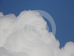 Closeup shot of large fluffy white clouds on a blue sky background