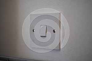 Closeup shot of a light switch on a white wall