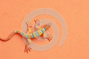 Closeup shot of lizard shaped rubber toy in color background