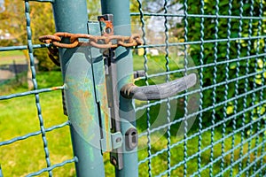 Closeup shot of a locked door with a grid fence