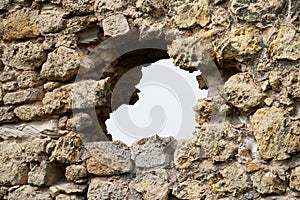 Closeup shot of a loophole on a defensive wall of a historic castle