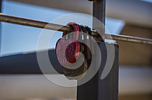 Closeup shot of love locks hung on a railing
