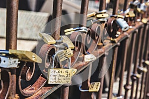 Closeup shot of love locks on an iron fence