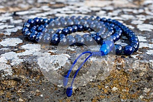 Closeup shot of mala beads on a stone photo