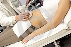 Closeup shot of a male doctor examining his patient using an ultrasound scanning machine