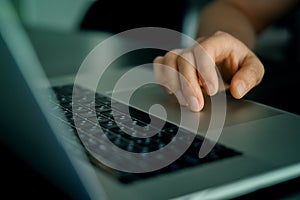 Closeup shot of male hand on touchpad of laptop