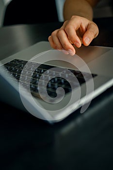 Closeup shot of male hand on touchpad of laptop