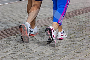 Closeup shot of a male's and female's feet on a walk