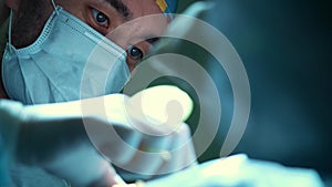 Closeup shot of male surgeon performing an operation. portrait of a surgeon at work. Saves life in intensive care.