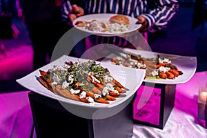 Closeup shot of a male who takes delicious food from a buffet table