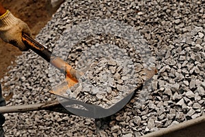 Closeup shot of man hand holding shovel and natural black charcoal for background. Picture idea about coal mining, coal processing