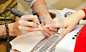 Closeup shot man making manicure to woman in beauty salon