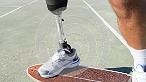 Closeup shot of man with prosthetic leg skateboarding outdoors