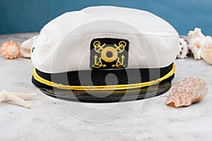 Closeup shot of a Marine civilian captain hat with sea shells and blue background