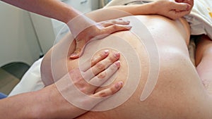 Closeup shot of masseur doing back massage
