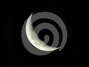 Closeup shot of a mesmerizing waning crescent moon on a black background
