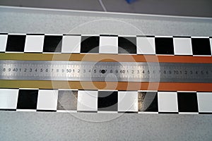 Closeup shot of a metal ruler on a cutting table