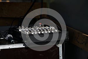 Closeup shot of a microphone and mixing console on stage