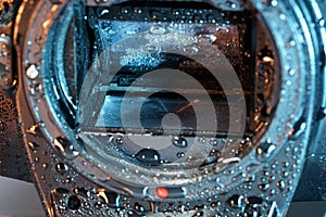 Closeup shot of a mirror box of a camera covered by water drops