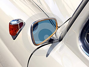 Closeup shot of a mirror of a white car