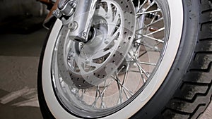 Closeup shot of a motorcycle wheel with white tires
