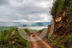 Closeup shot of a mountain road in the cloudy crater of the Ngorongoro National Park, Tanzania photo