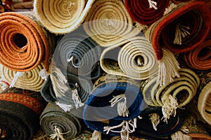 Closeup shot of multicolour rolls of carpets in a carpet store in India