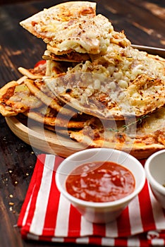 Closeup shot multiple stack hot oven baked tasty delicious Italian homemade ham pineapple traditional Hawaiian bread crust pizzas