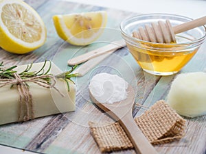 Closeup shot of natural skincare product ingredients: lemon, baking soda, honey, and natural soap