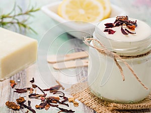 Closeup shot of natural skincare product ingredients: natural soap, yogurt, and lemon