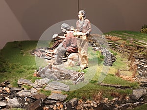 Closeup shot of a Neapolitan nativity hunter and gatherer figures on a green grass